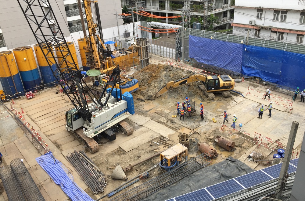 Workers,In,Construction,Area,With,Crane,Truck,And,Holding,Machine